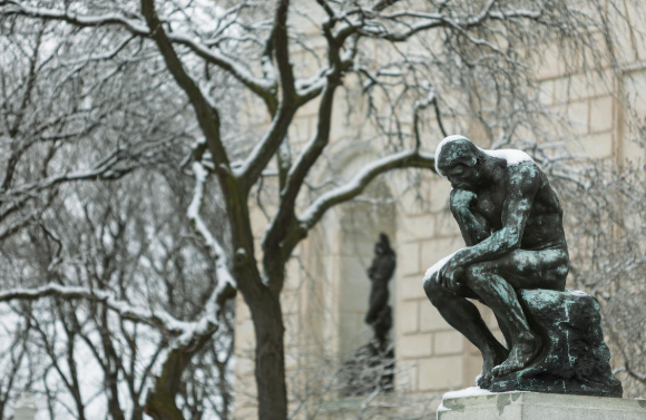 Auguste Rodin, The Thinker, nude figure seated on rock.